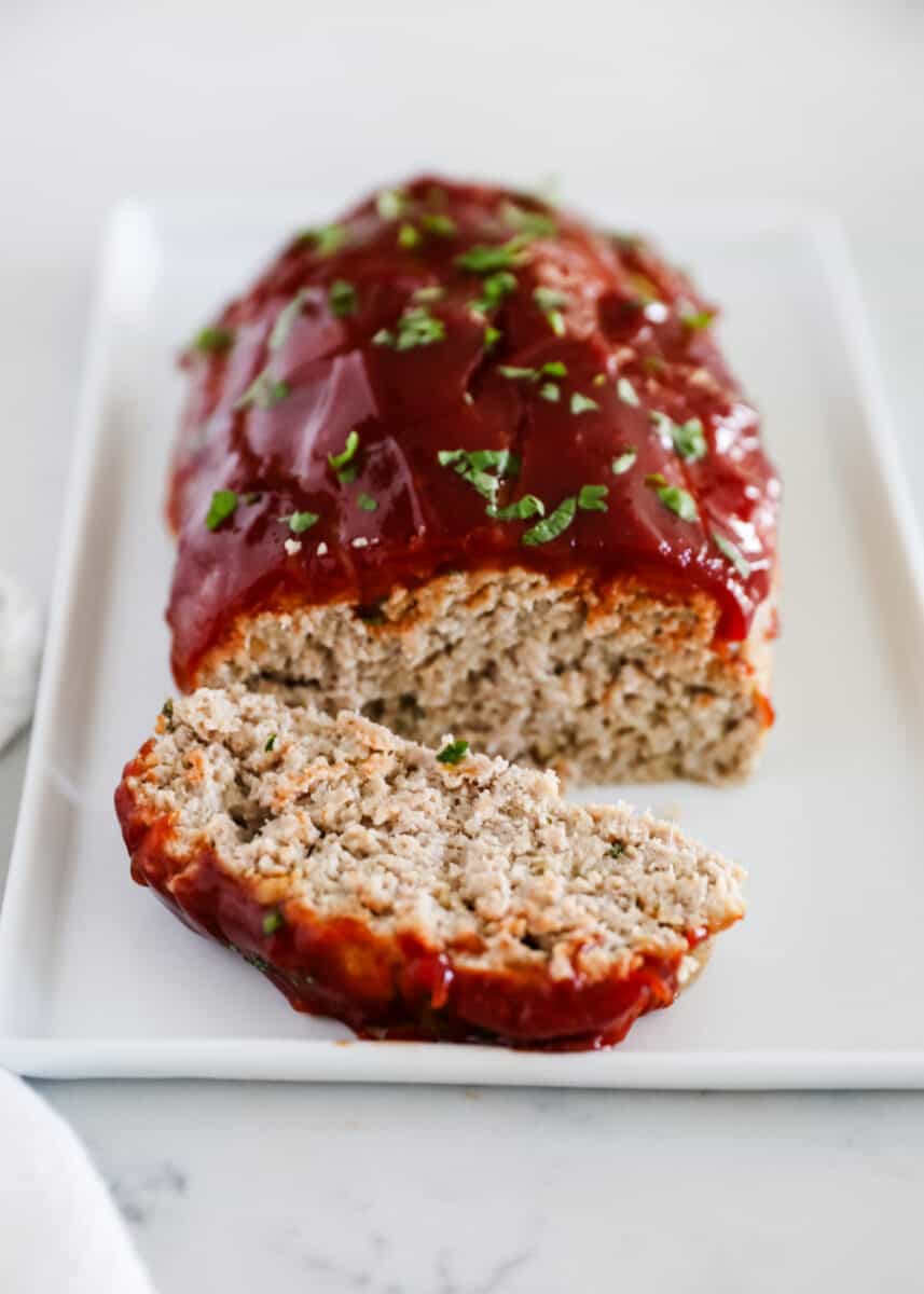 This ground turkey meatloaf is a lighter spin on a classic comfort food. It's packed with lean protein and tastes moist, tender and super flavorful. sliced turkey meatloaf