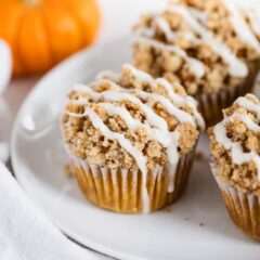 A plate with pumpkin crumb muffins with crumble topping.