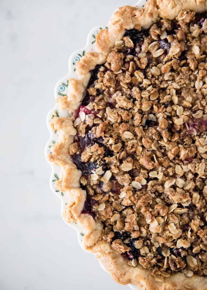 Berry pie with crumb topping on counter.