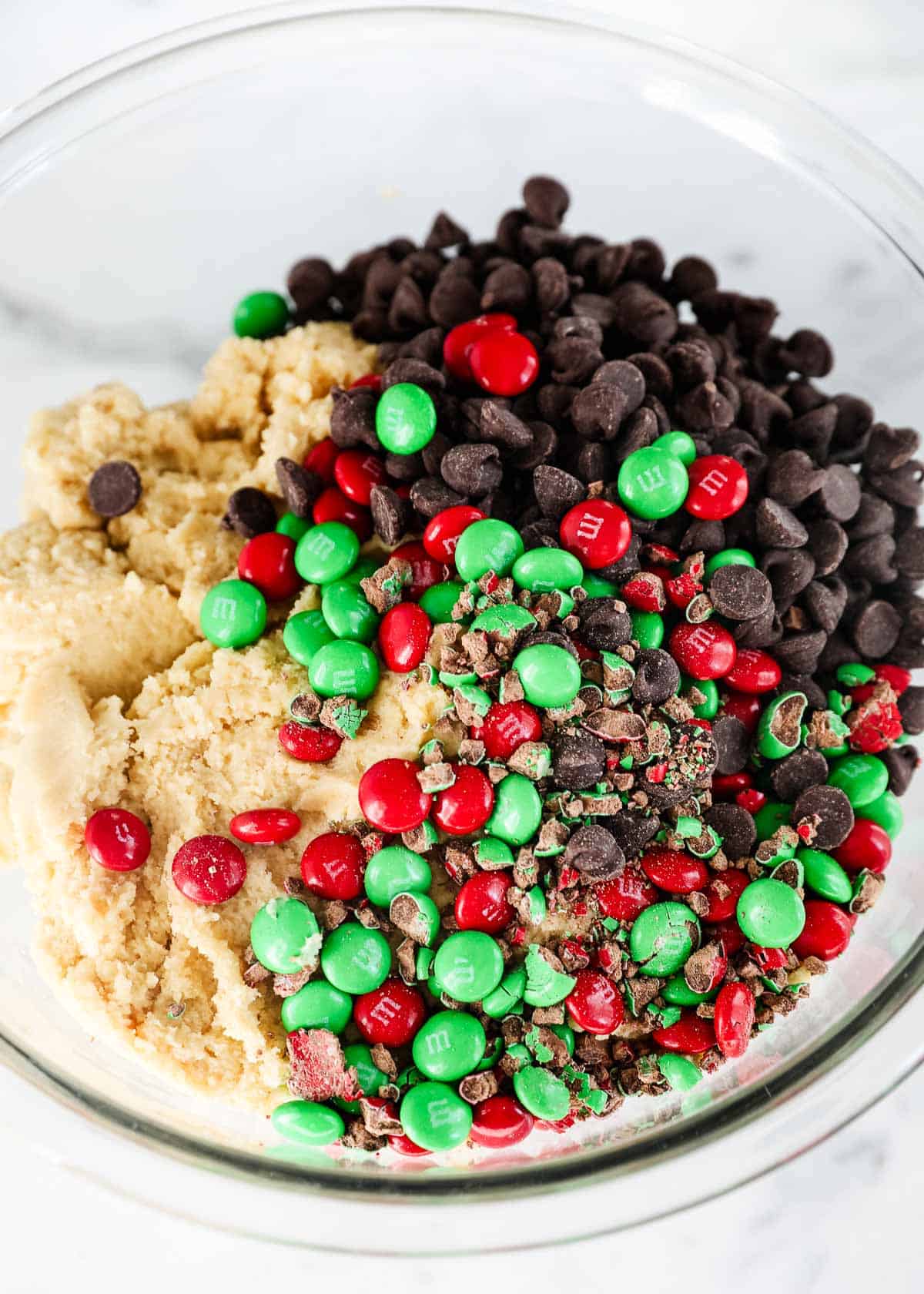 M&M Christmas cookie dough in bowl.