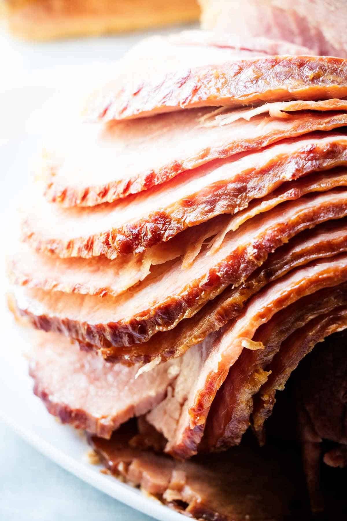 Sliced baked ham on plate.