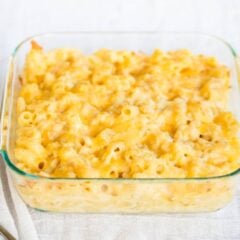 Creamy baked macaroni and cheese in glass dish.