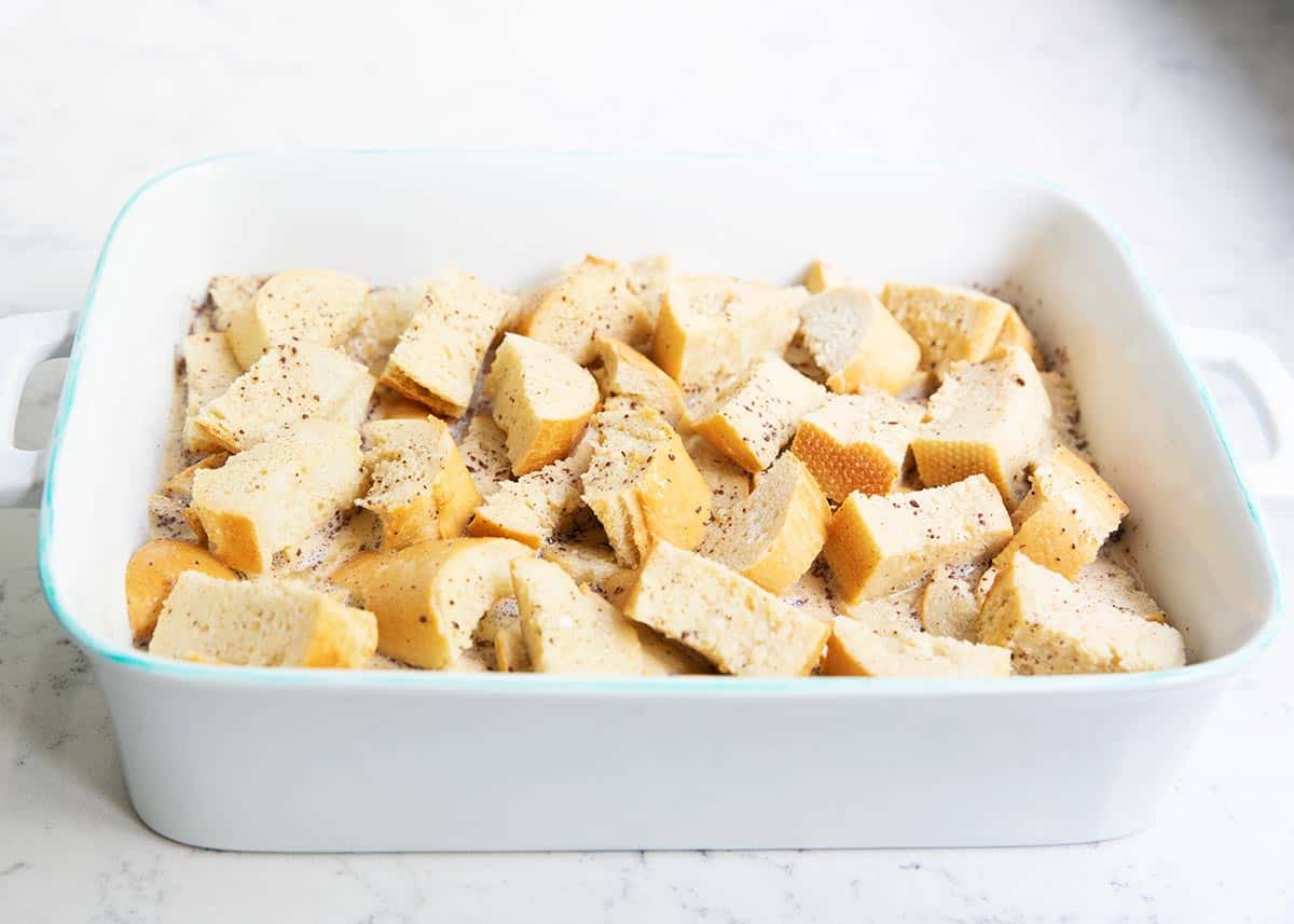 Cubed bread in baking dish.