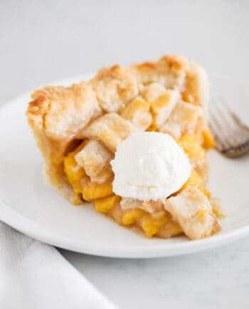 slice of peach pie with ice cream