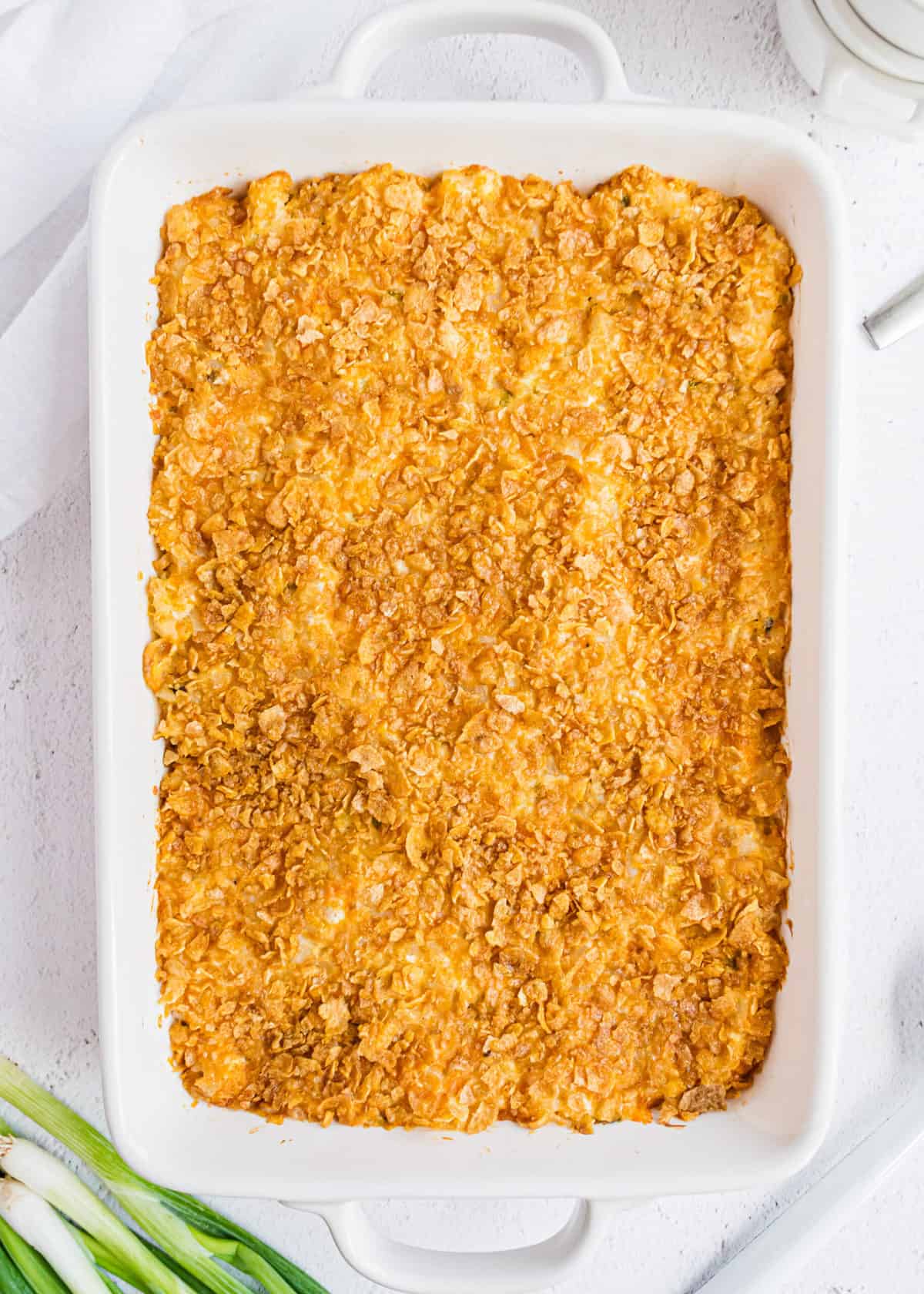 Funeral potatoes in white pan.