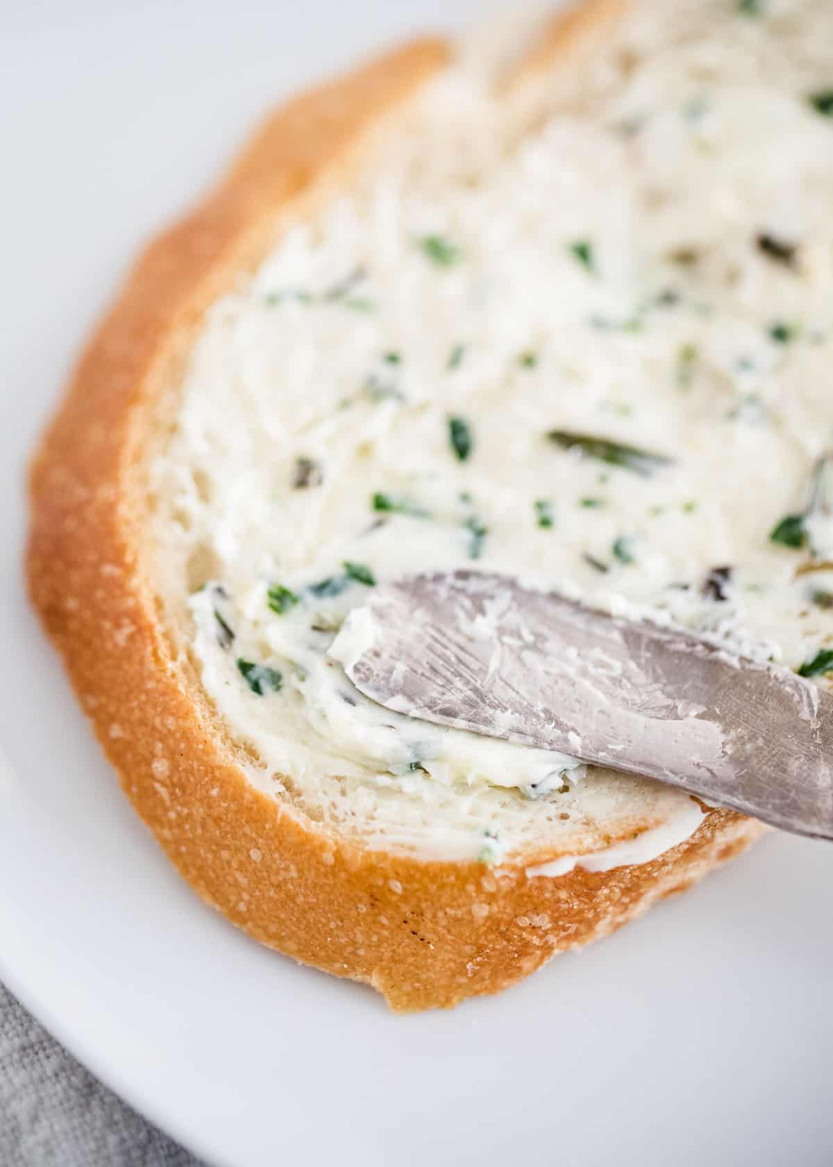 Herb butter spread onto bread.