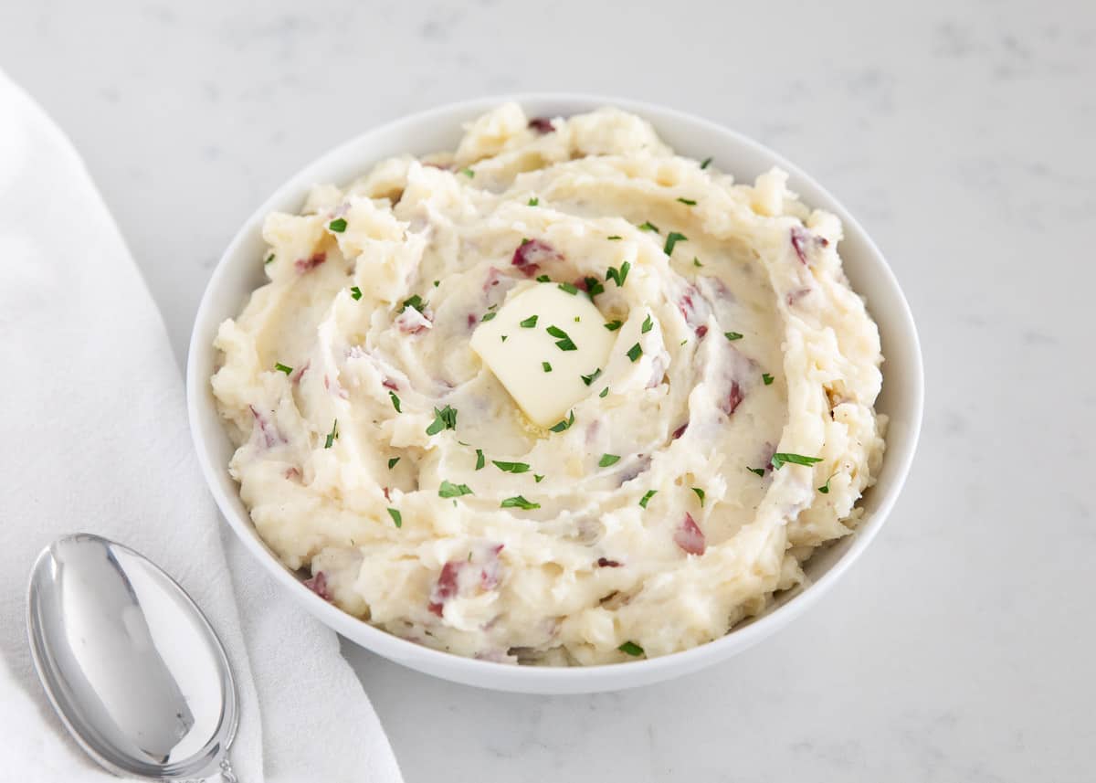Mashed potatoes in white bowl.