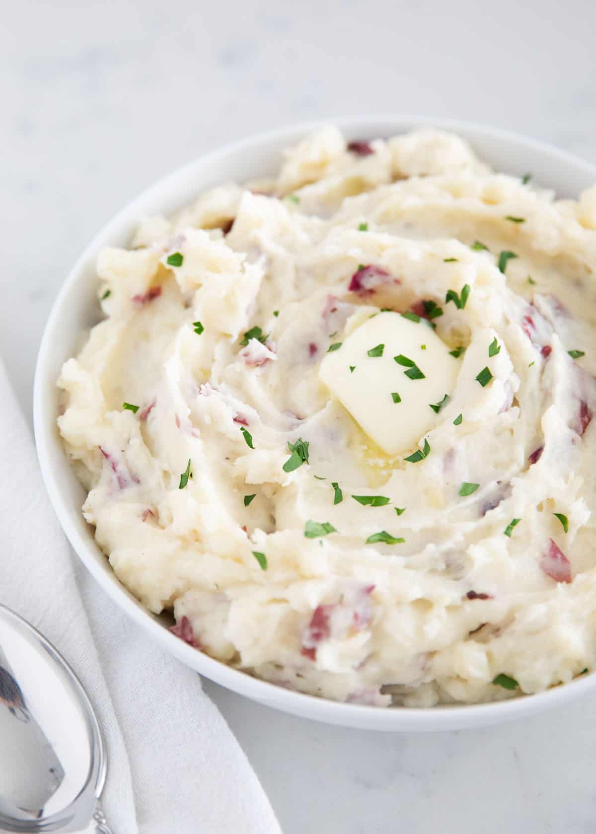 Garlic red mashed potatoes in white bowl.