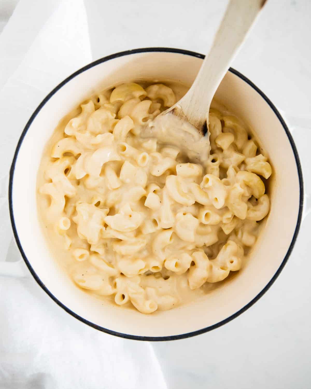 Mac and cheese in white pot.