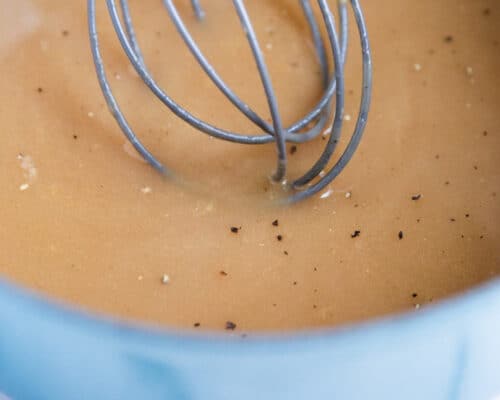 whisking turkey gravy in pan