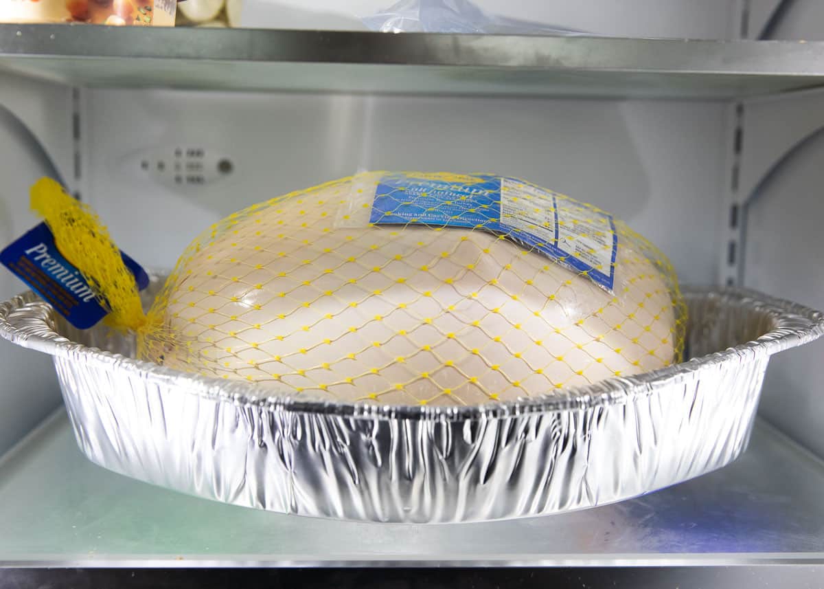 Thawing frozen turkey in fridge.