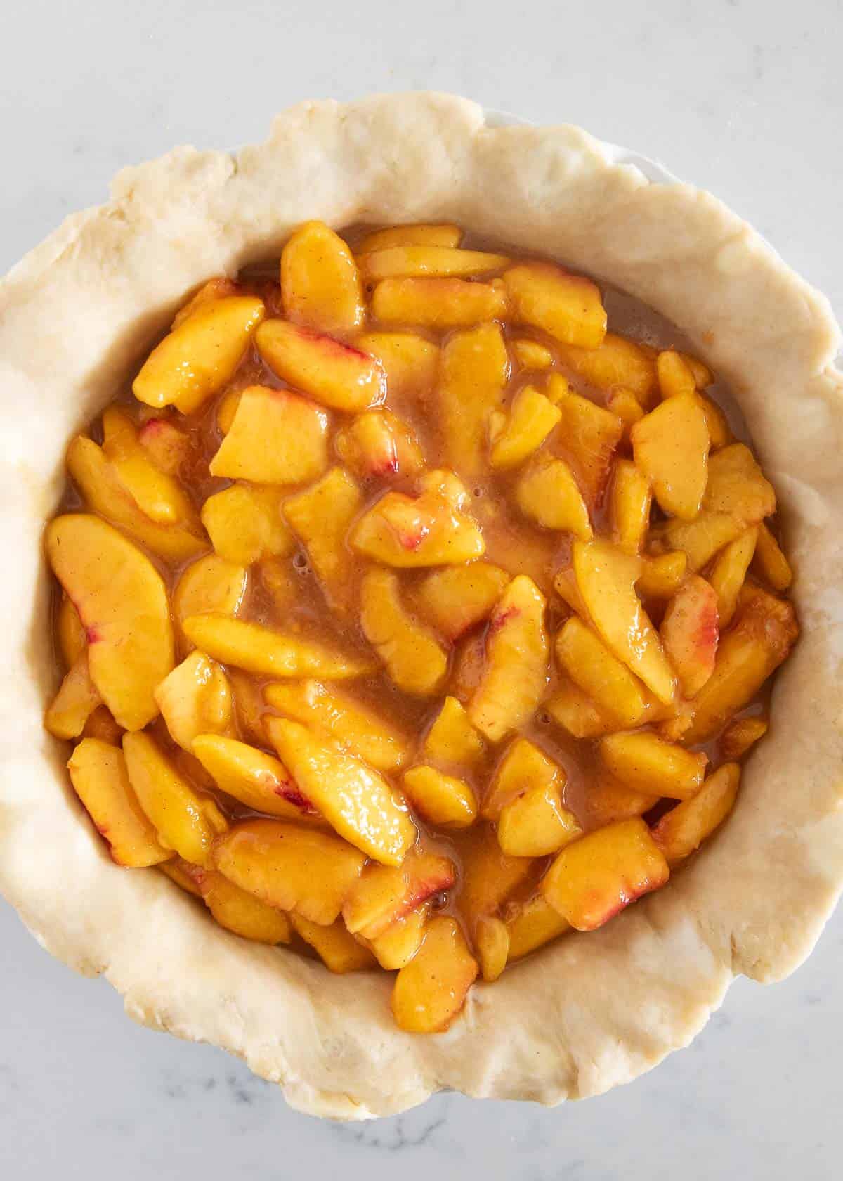 Peach pie filling in pie crust.