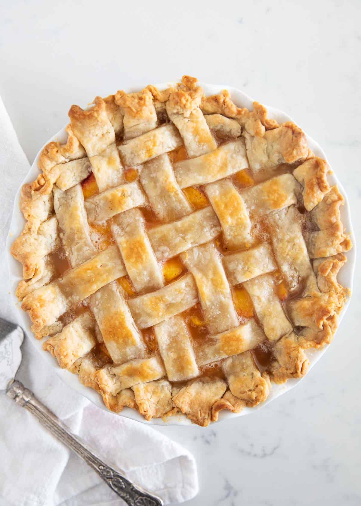 Peach pie on marble counter.