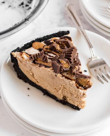 Slice of Oreo peanut butter pie on a plate with a fork.
