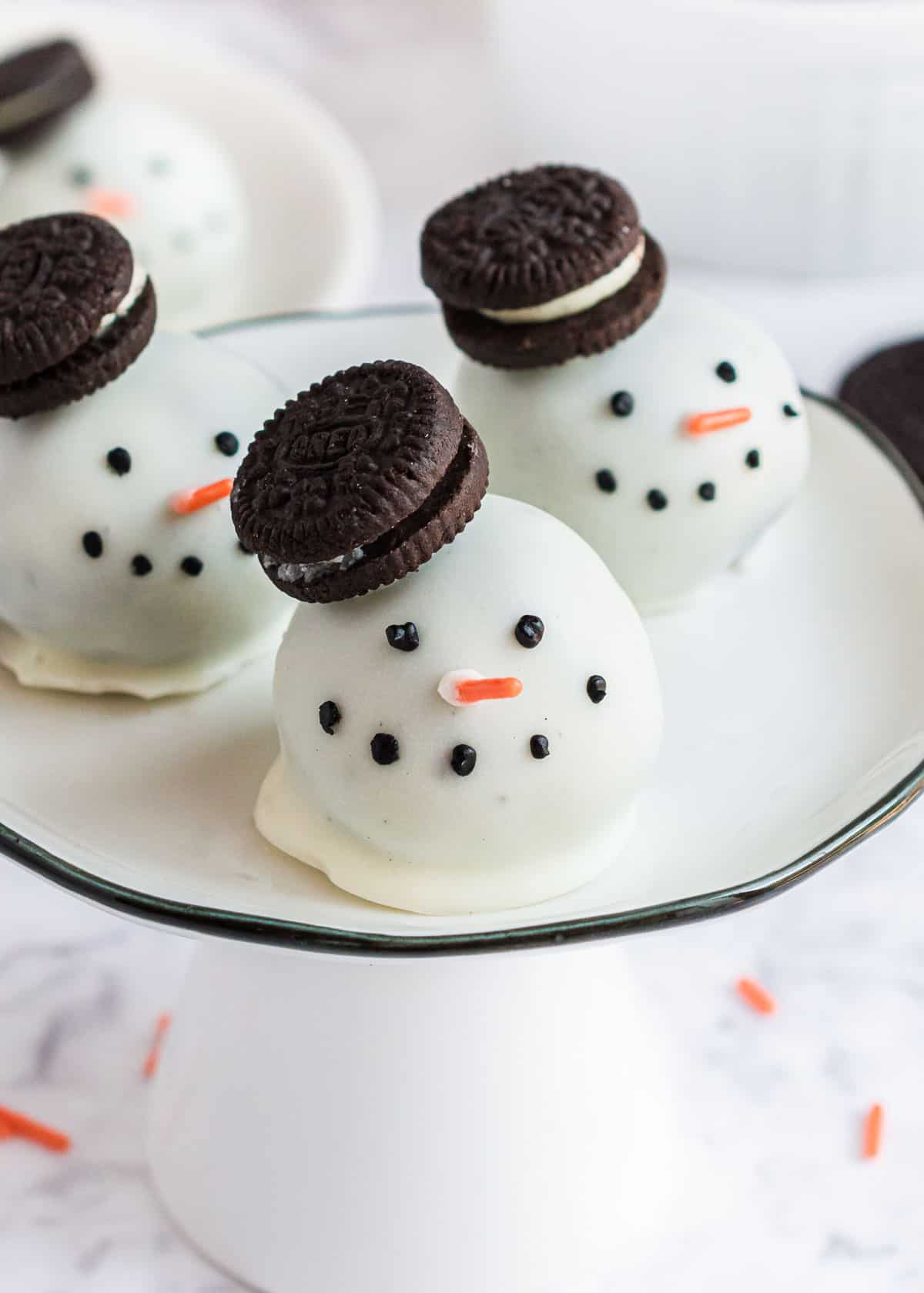 Snowman oreo balls with oreo hat.