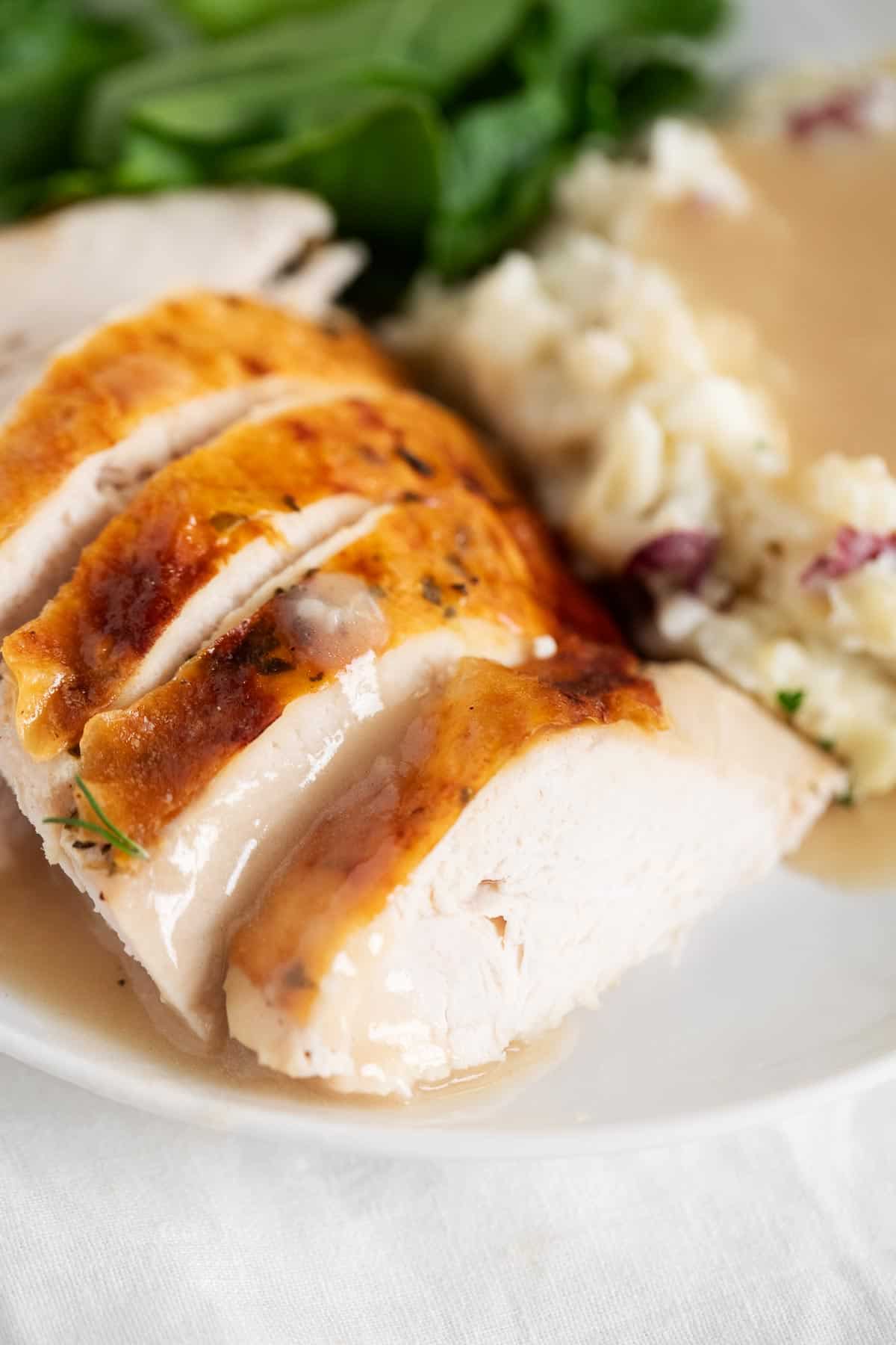 Turkey with gravy on plate.