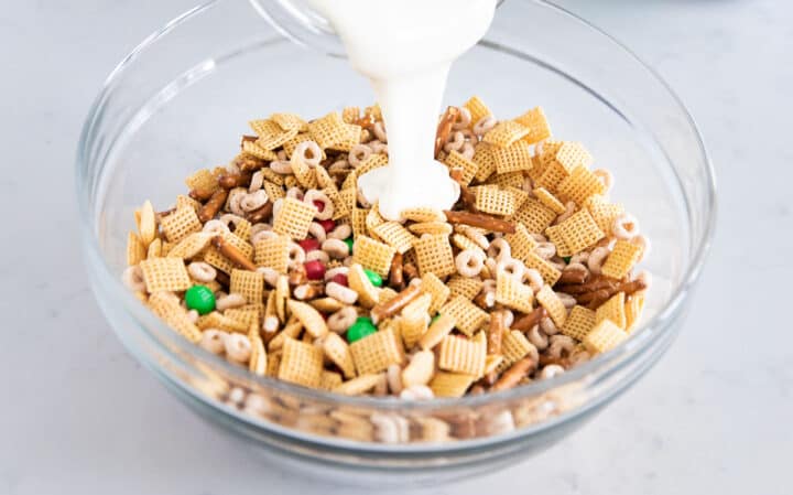 chex mix, pretzels, cheerios, and m&ms in bowl