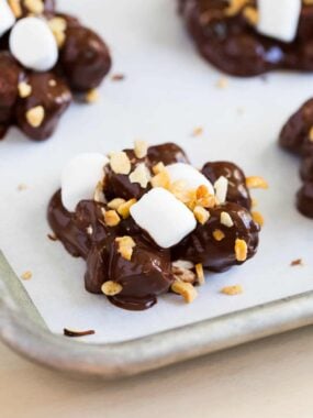 Close up of rocky road candy on a parchment lined baking sheet.