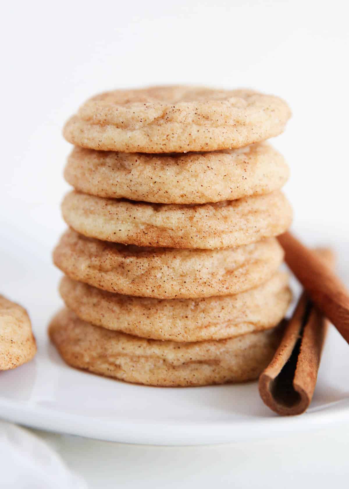 Stack of snickerdoodle cookies on a white plate.