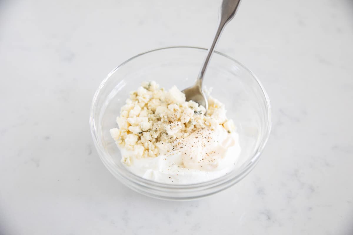 Blue cheese dressing ingredients in bowl.