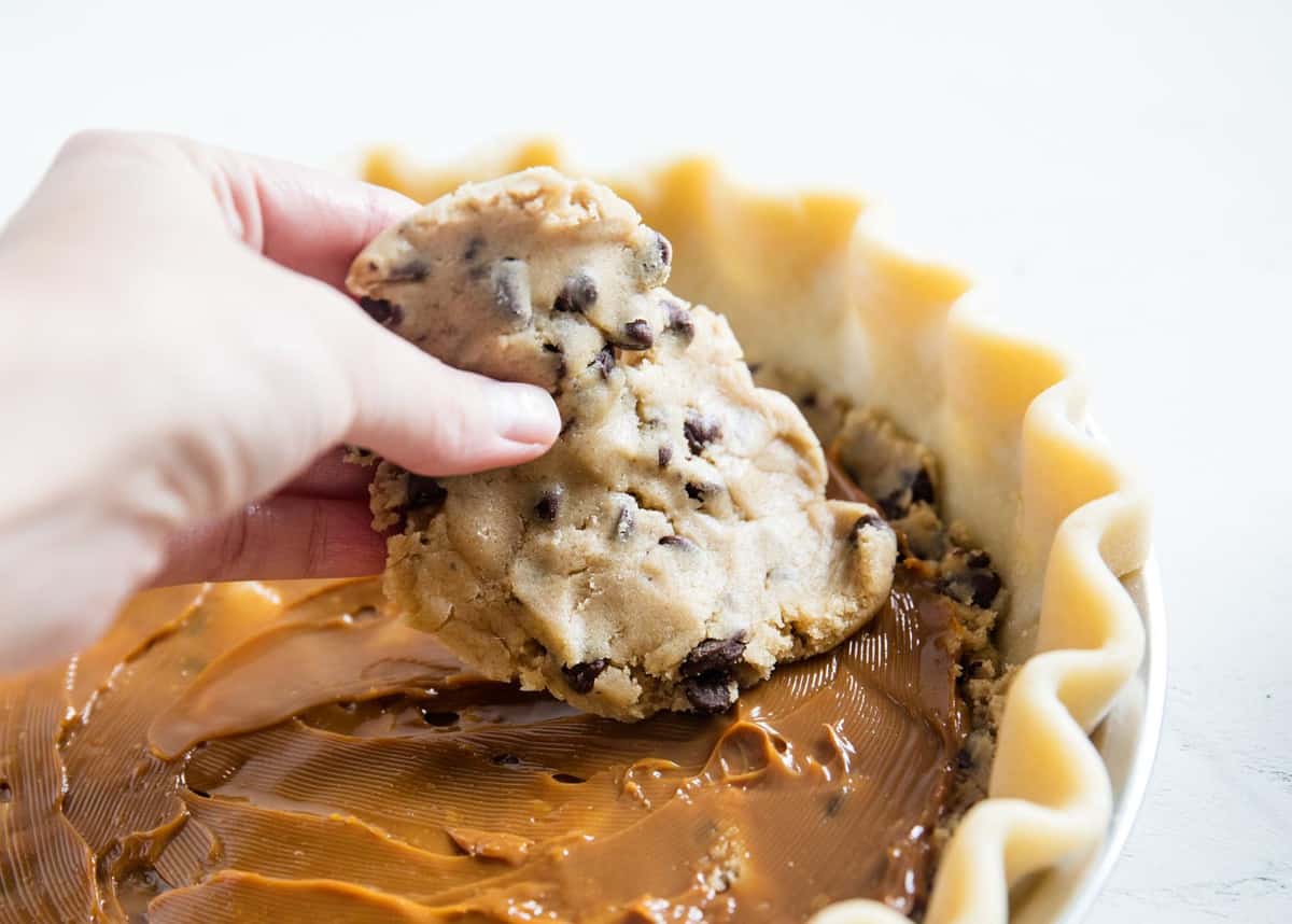 Placing dough on top of caramel.