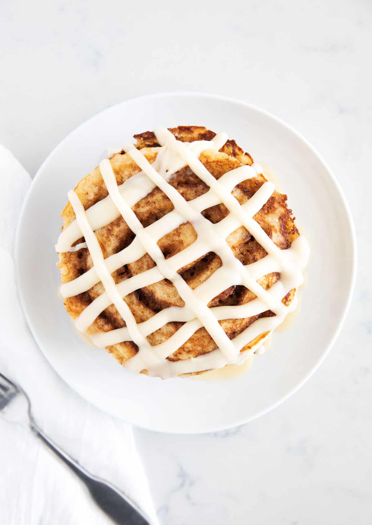 Cinnamon roll pancakes on plate.