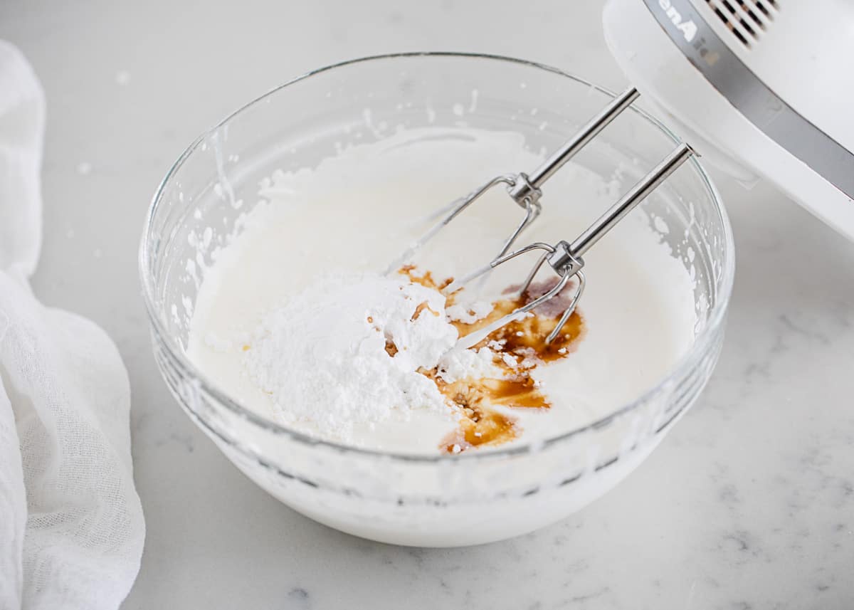 Mixing cream in bowl.