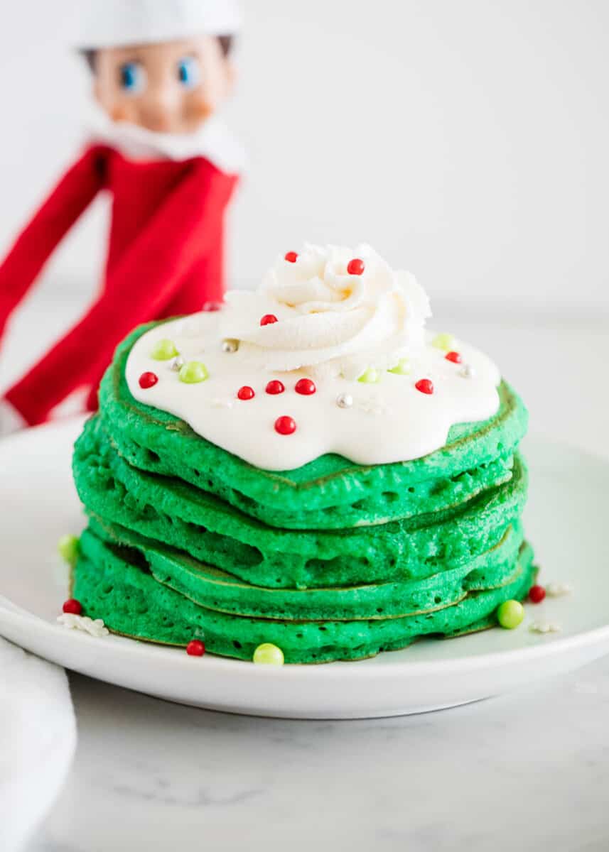 Elf on the shelf green pancakes with whipped cream on top.