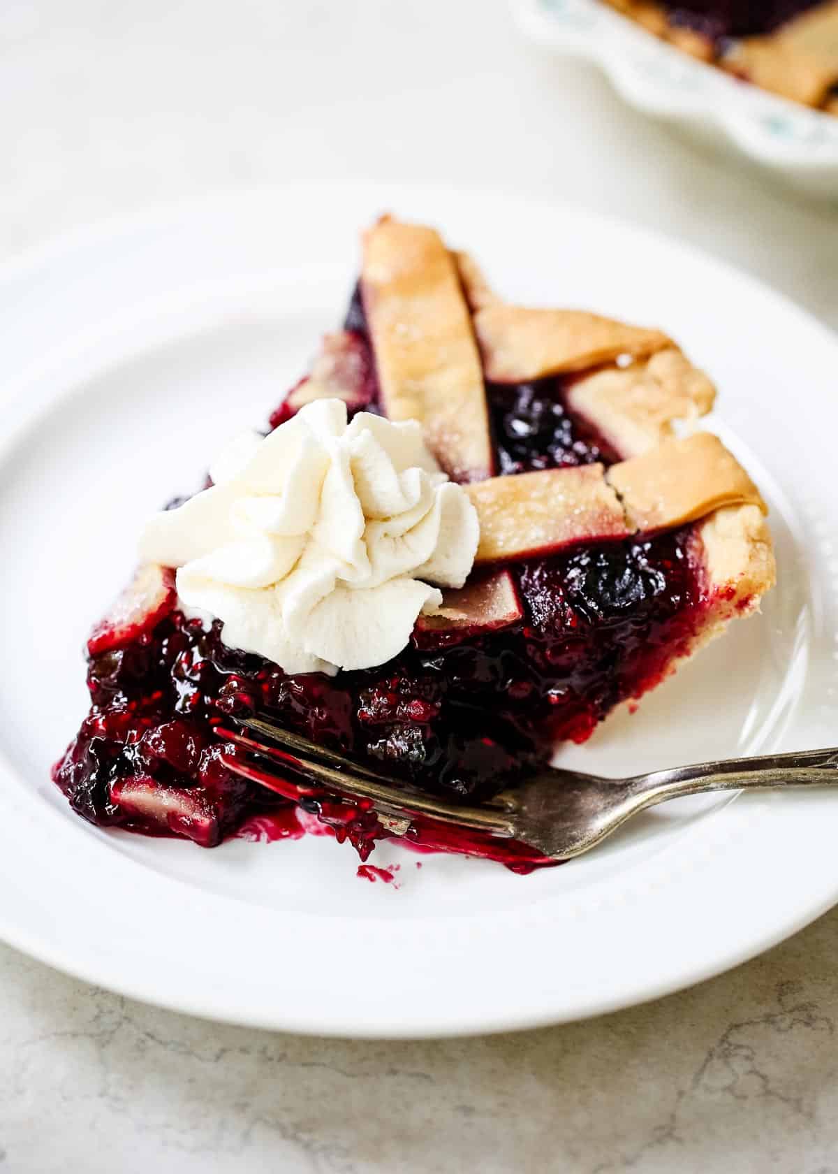 Slice of razzleberry pie on plate.