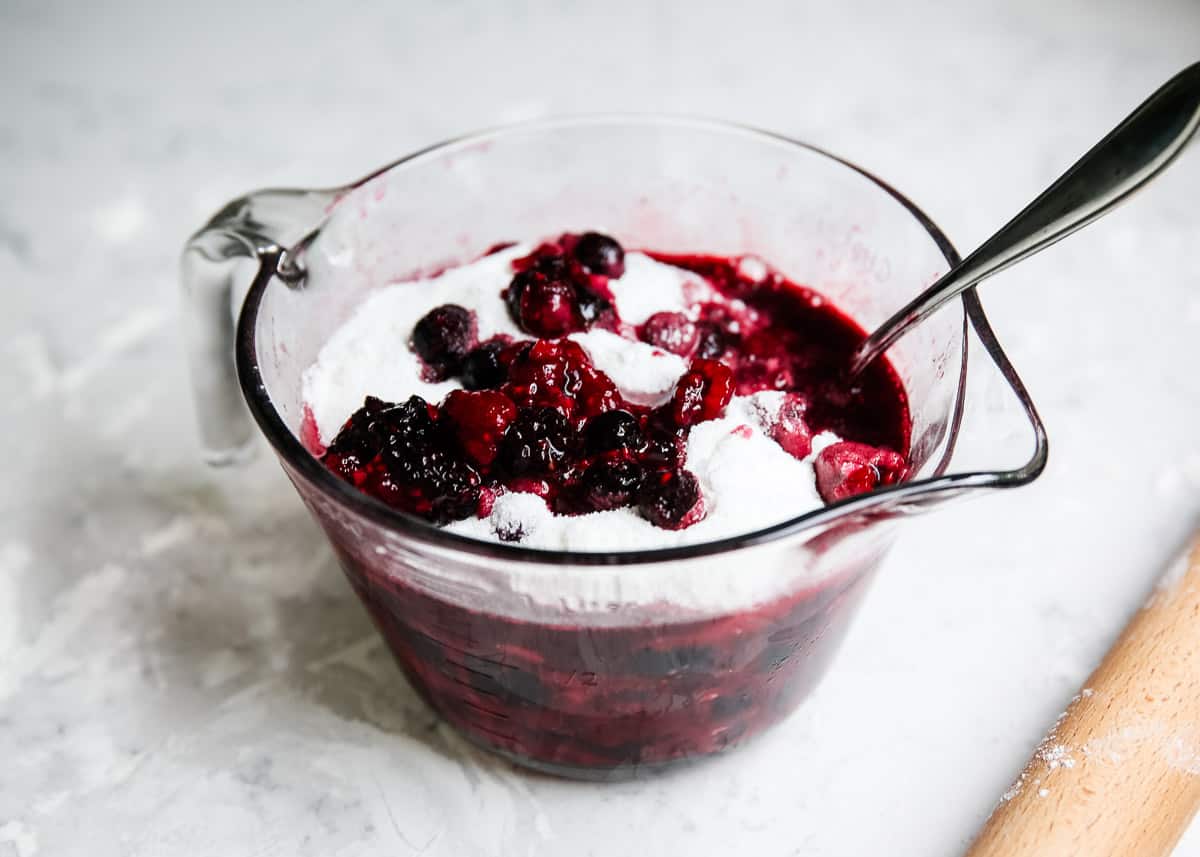 Berries with sugar in bowl.