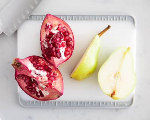 pear and pomegranate on cutting board