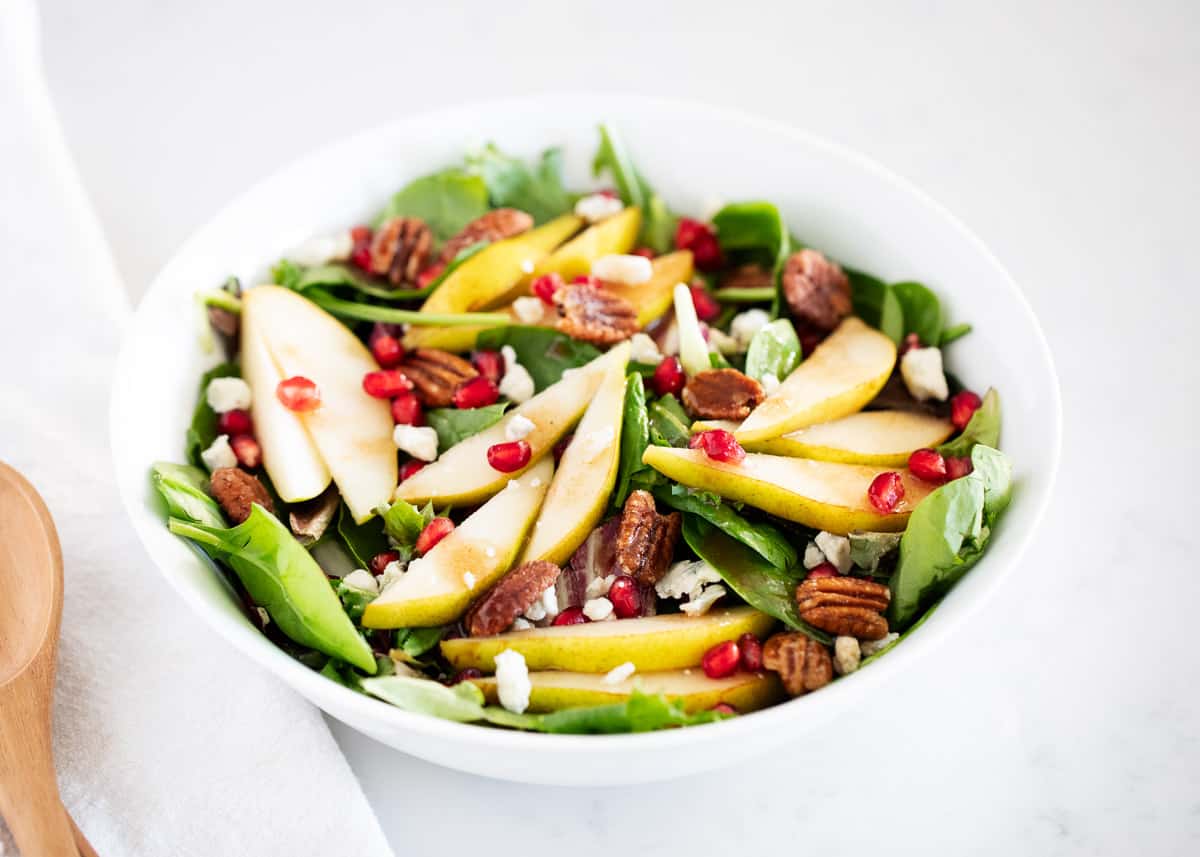 Pear salad in white bowl.