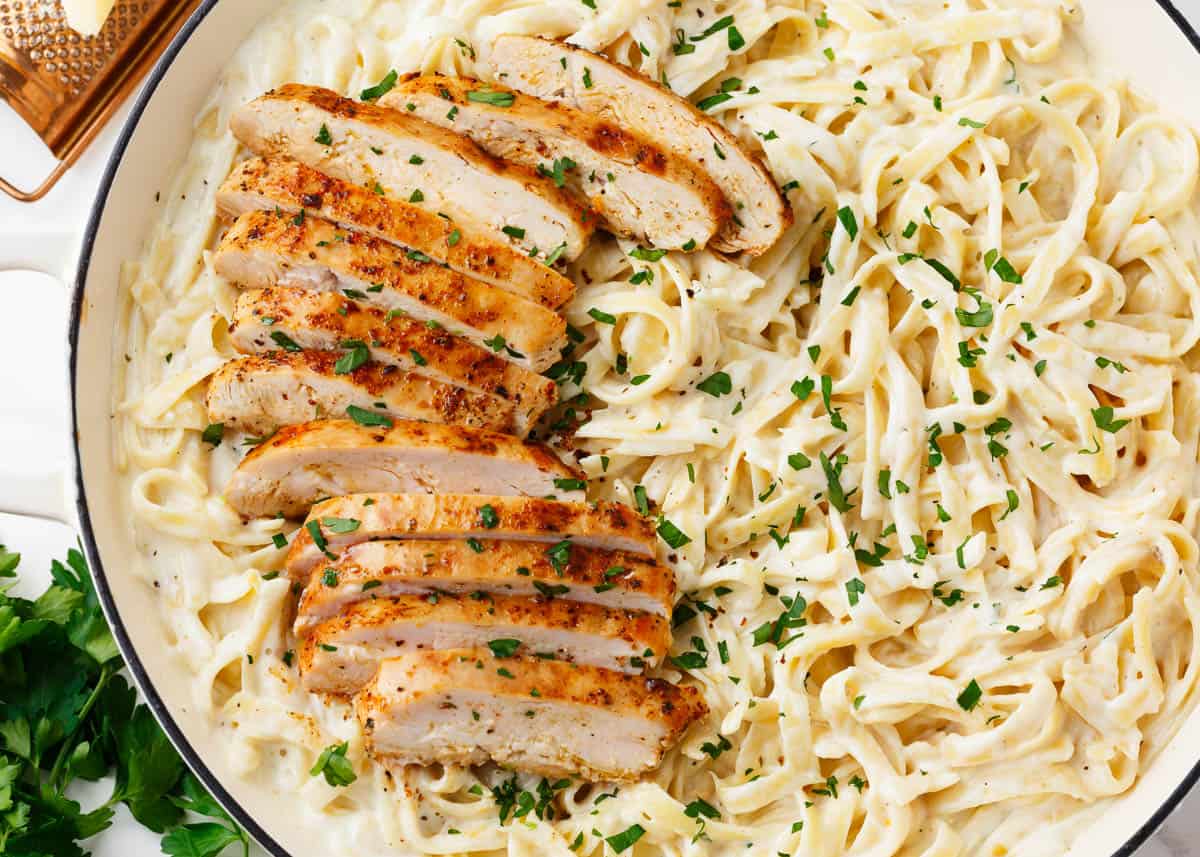 Chicken alfredo in a white pot. 