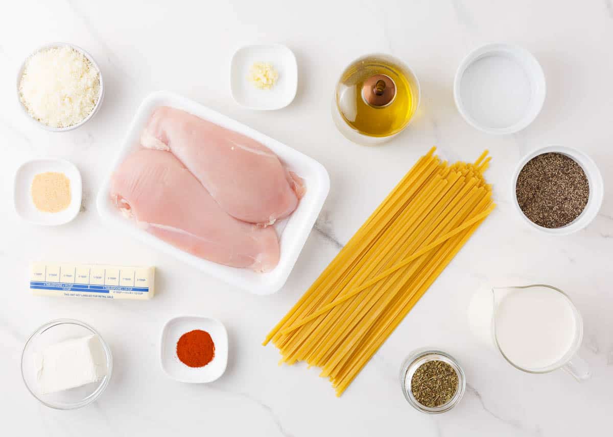 Chicken alfredo ingredients on counter. 