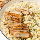 Chicken alfredo in a bowl with fettuccini noodles.