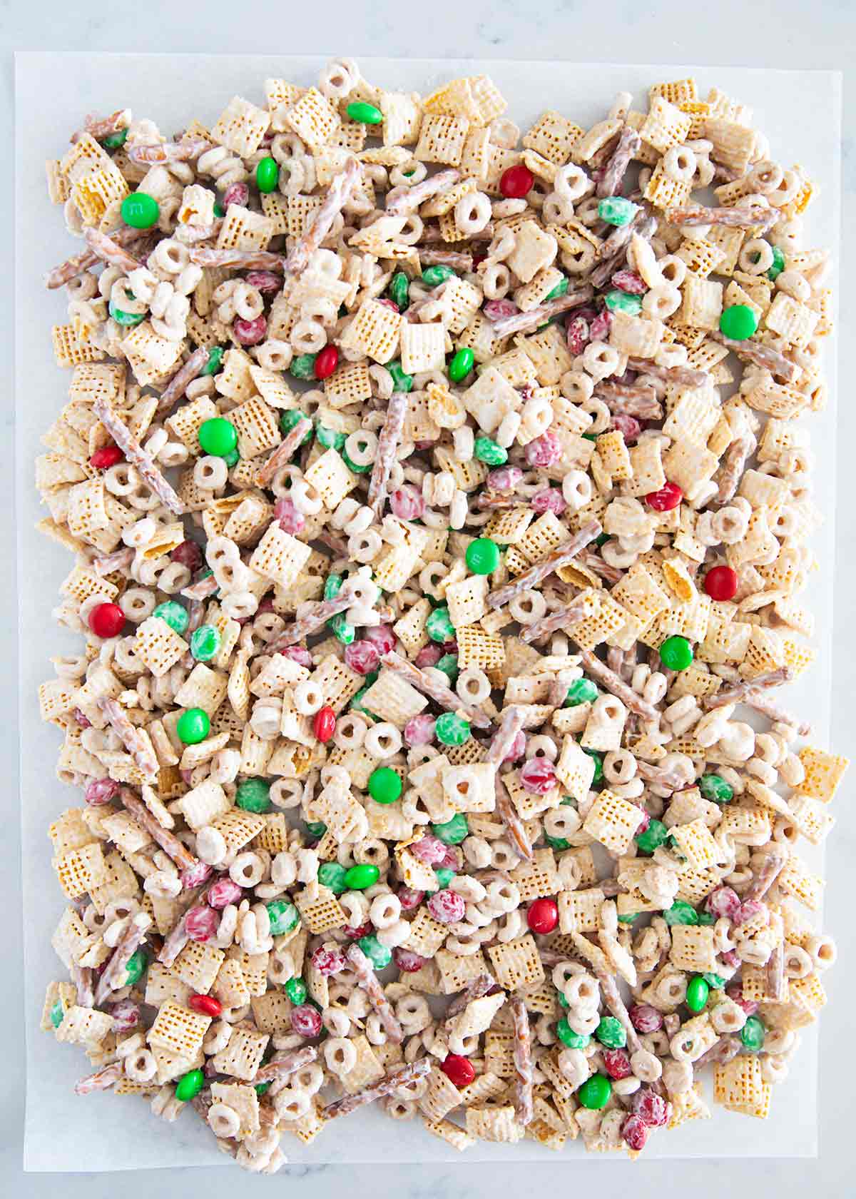 Christmas chex mix on parchment paper.