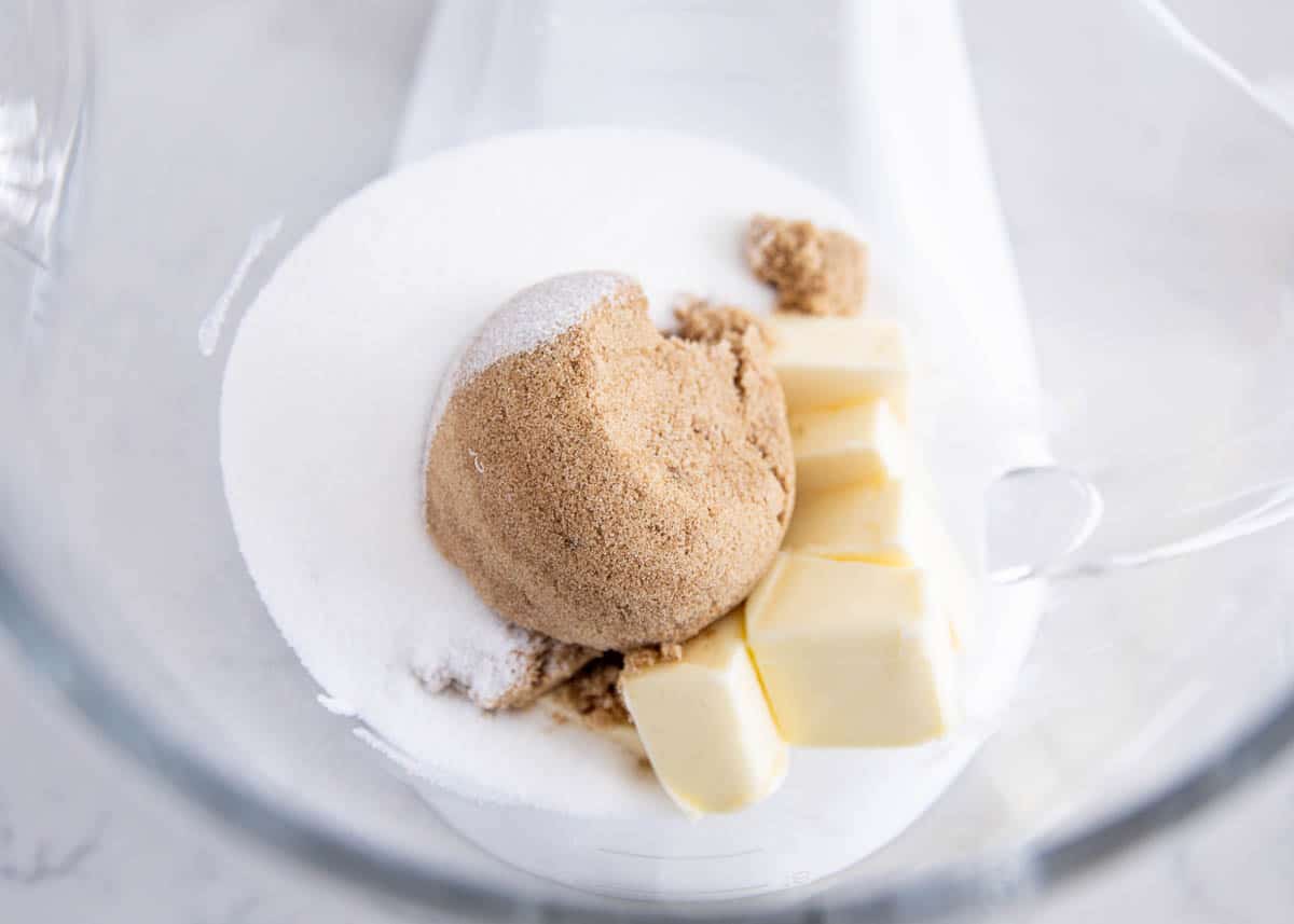 White chocolate cranberry cookies are soft, chewy, and chunky loaded with white chocolate and dried cranberries. A delicious festive cookie perfect for the holidays! Butter and brown sugar being combined in a mixing bowl to start white chocolate cranberry cookies.