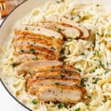 Chicken alfredo in a bowl with fettuccini noodles.