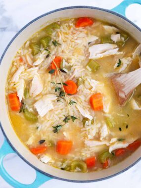 Chicken and rice soup in a blue pot.