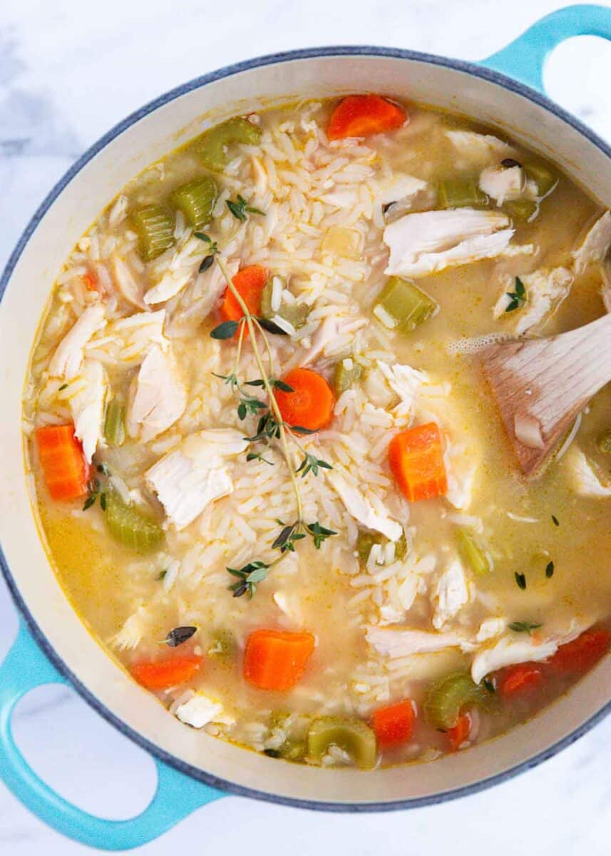 Chicken and rice soup in a blue pot.