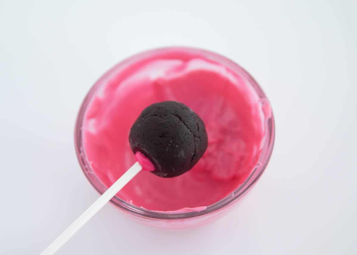 dipping cake pop in pink chocolate