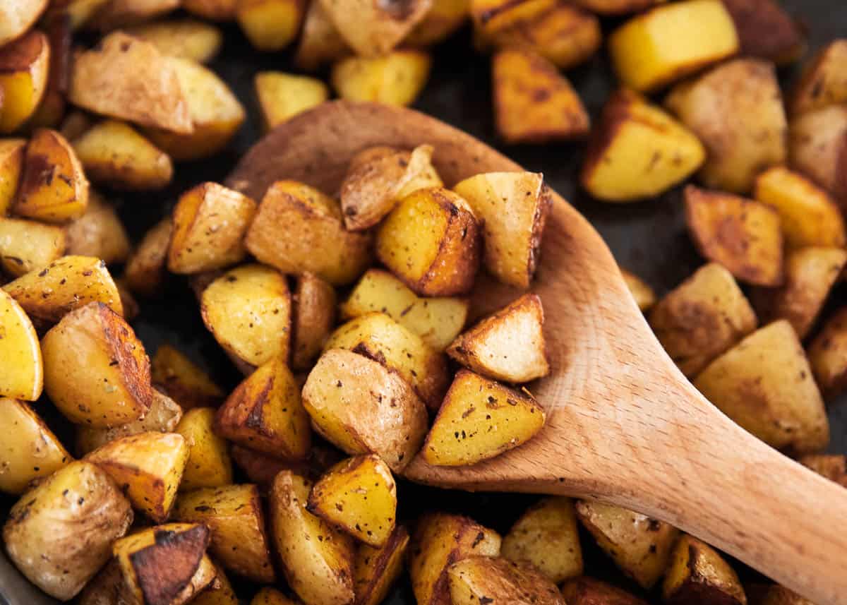 These easy cast iron skillet potatoes are crispy and golden on the outside, tender on the inside, and the perfect 20 minute, one-pan side dish with loads of buttery herbed flavor in every bite! Cast iron skillet potatoes in pan close up.