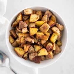 cast iron skillet potatoes in white bowl