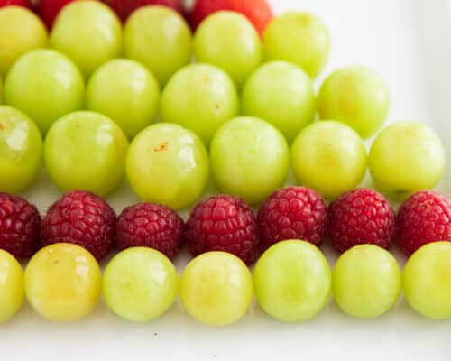 grapes and raspberries on platter