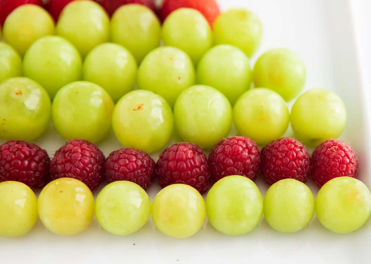 grapes and raspberries on platter