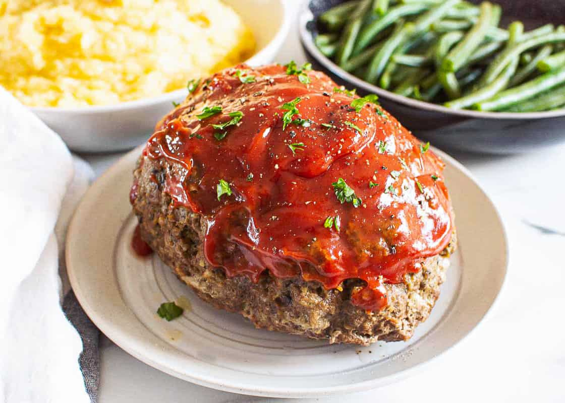 Meatloaf with sauce on plate.