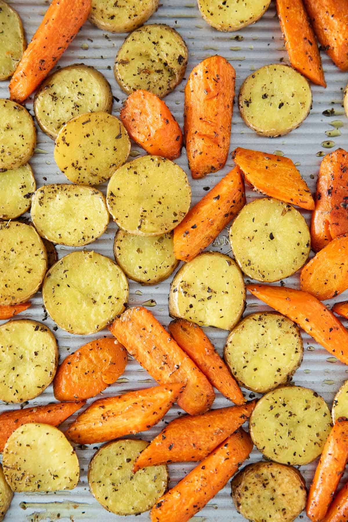 Roasted potatoes and carrots on pan.