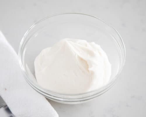 sour cream frosting in clear bowl