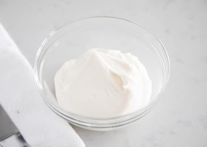 sour cream frosting in clear bowl