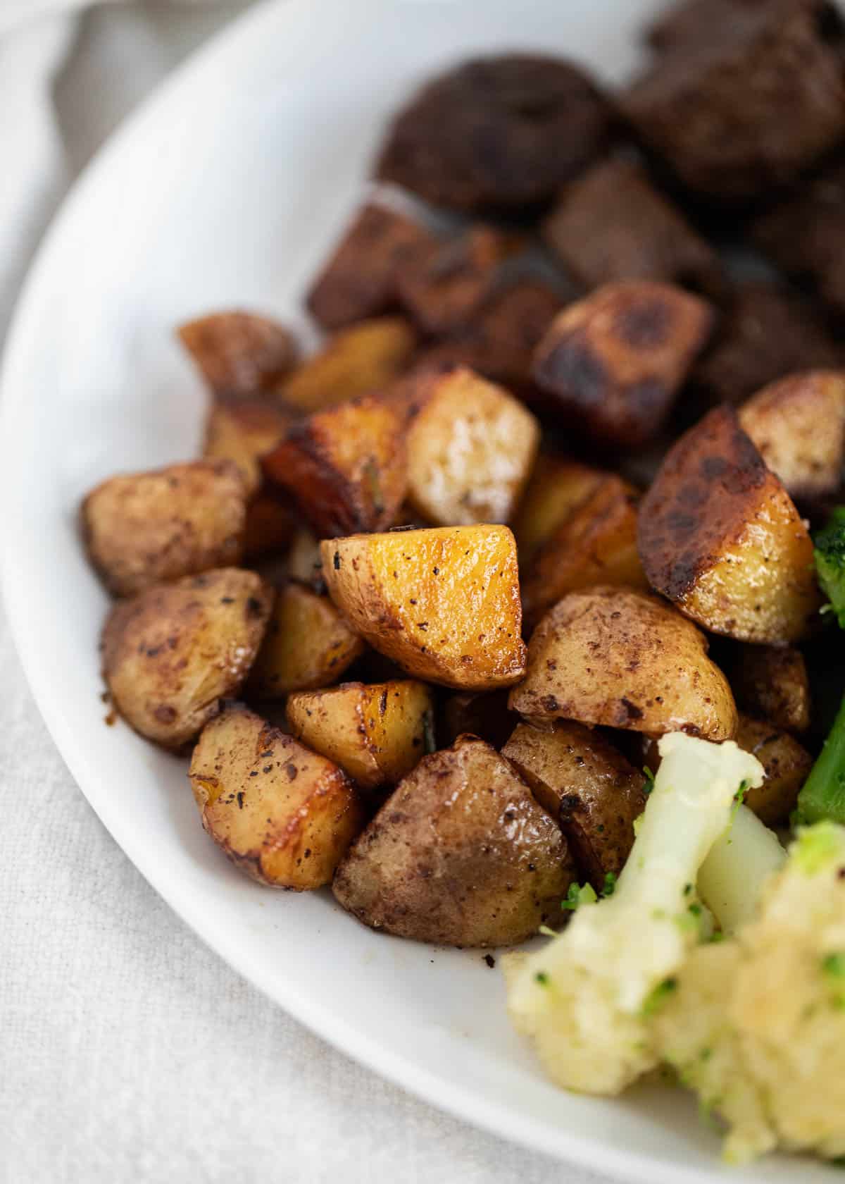 Steak and potatoes close up on plate.